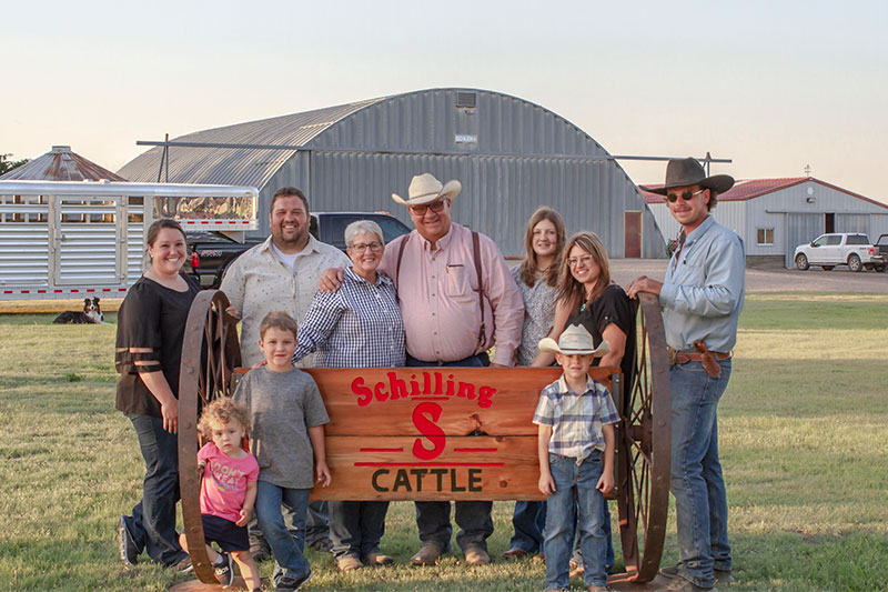 The Schilling family gathered around their ranch sign.